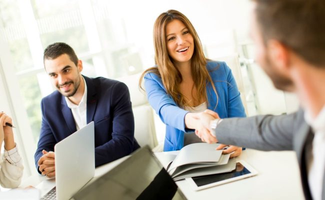 Business people shaking hands, finishing up a meeting Business people shaking hands, finishing up a meeting